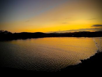 Scenic view of sea against romantic sky at sunset