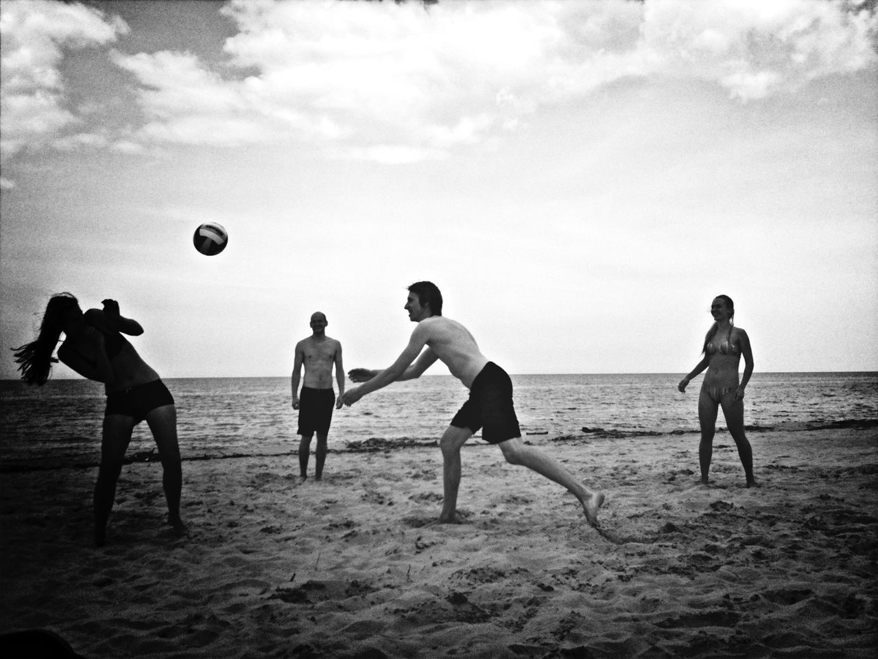 beach, leisure activity, lifestyles, sand, sky, full length, childhood, boys, mid-air, fun, men, enjoyment, shore, vacations, playing, sport, flying, cloud - sky, togetherness