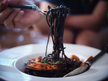 Close-up of person holding food in plate