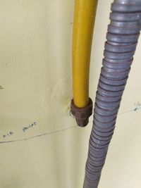 High angle view of yellow pipe on wall