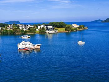 Boats in sea against sky