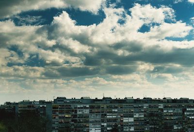 Buildings against cloudy sky