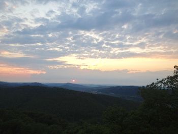 Scenic view of silhouette mountains against sky at sunset