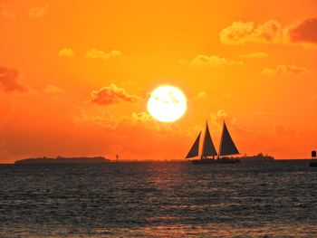 Scenic view of sea against orange sky