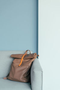 Lovely mocha color backpack on an armchair.