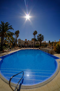 Sun shining over swimming pool