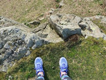 Low section of person standing on rock