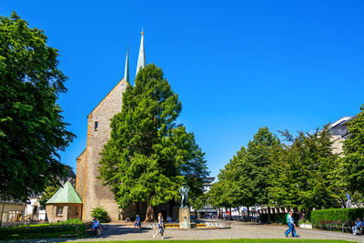 Group of people in temple against clear blue sky