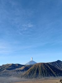 Morning view of volcanic bromo mountain against blue sky