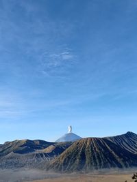 View of volcanic mountain against blue sky