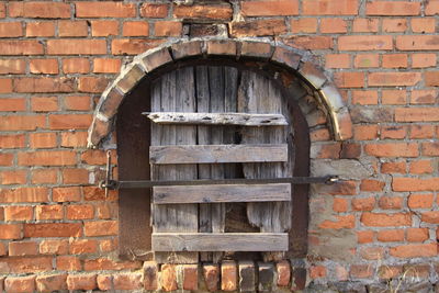 Close-up of window on brick wall of building