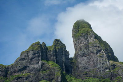 Low angle view of rock formation against sky