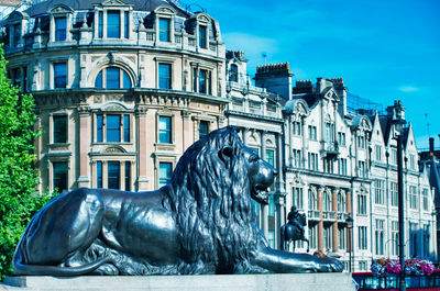 Statue against building in city