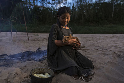 Full length of girl sitting on land