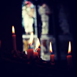Close-up of burning candles in church