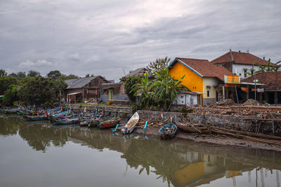 Boats in lake against sky