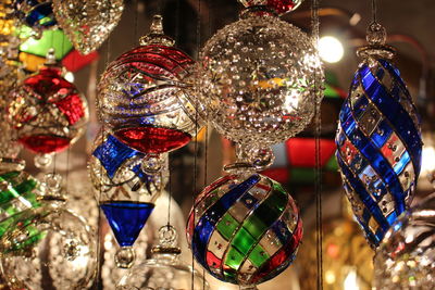 Close-up of decorations hanging in market for sale