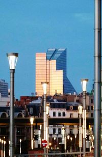 Buildings in city against clear blue sky