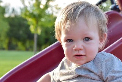 Close-up portrait of cute baby boy at park