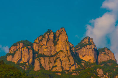 Low angle view of rock formation against sky