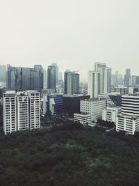 Modern buildings in city against clear sky