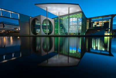 Reflection of illuminated buildings in swimming pool