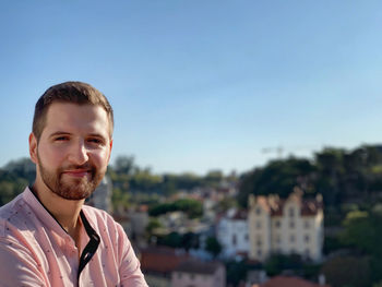 Portrait of young man against clear sky