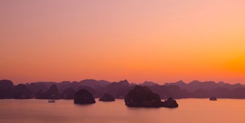 Scenic view of sea against orange sky