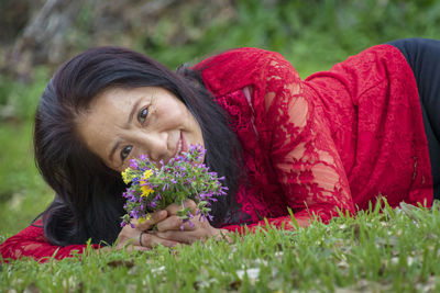 Portrait of woman with red flowers