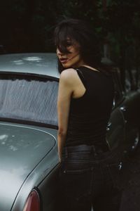 Young woman looking down while sitting in car