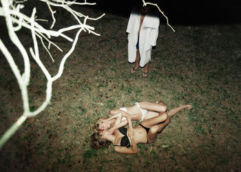 Low section of woman with toy on field