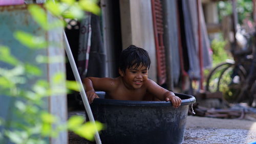 Portrait of shirtless boy in water