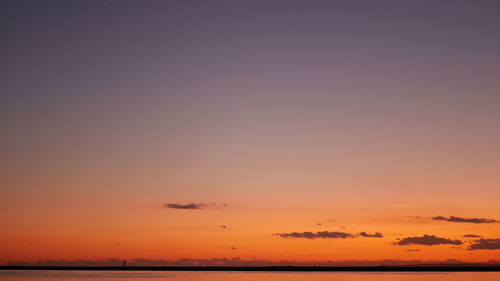 Scenic view of sea against romantic sky at sunset