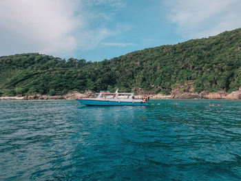 Boats, turquoise water and white sand beach, redang island, malaysia