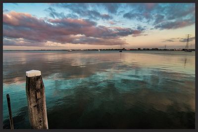 Scenic view of lake against sky during sunset