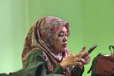 Woman wearing hijab using mobile phone