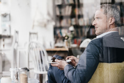 Businessman in cafe eating cake