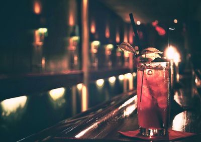 Close-up of drink on table at illuminated bar