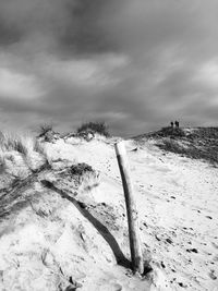 Scenic view of snow covered land against sky