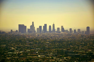 Cityscape against clear sky during sunset