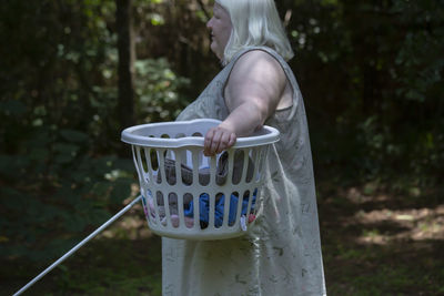 Blind woman carrying a laundry basket