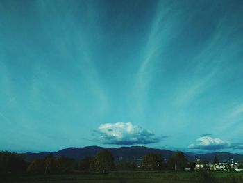 Scenic view of landscape against blue sky