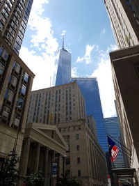 Low angle view of modern skyscraper against sky
