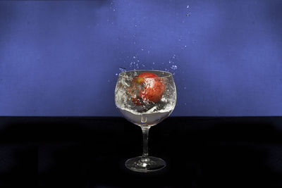 Close-up of wine glass against black background