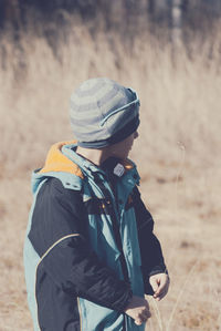 Cute boy standing on field