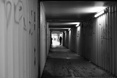 People walking in corridor of building