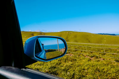 Reflection on side-view mirror of car