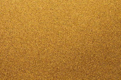 Full frame shot of golden glitter
