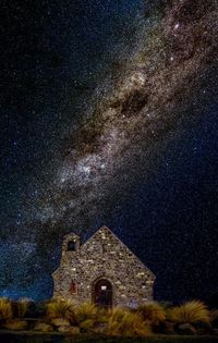 Low angle view of old building against sky at night