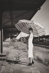 Full length of woman standing by railing